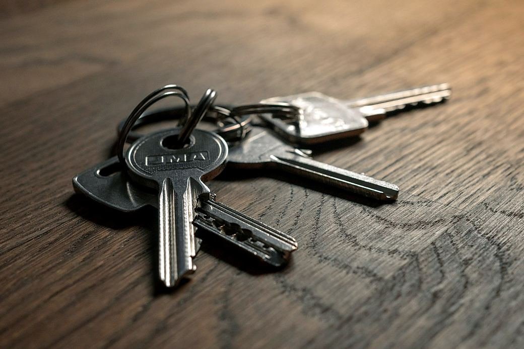 A bunch of keys left on a wooden table