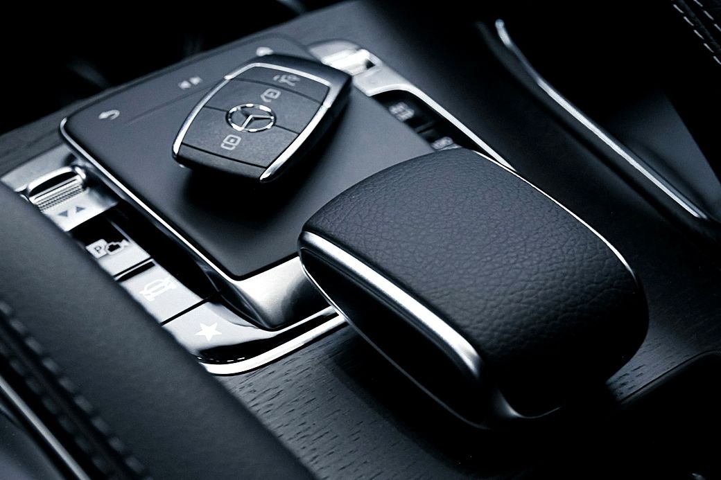 A Mercedes key fob on the centre console of a car