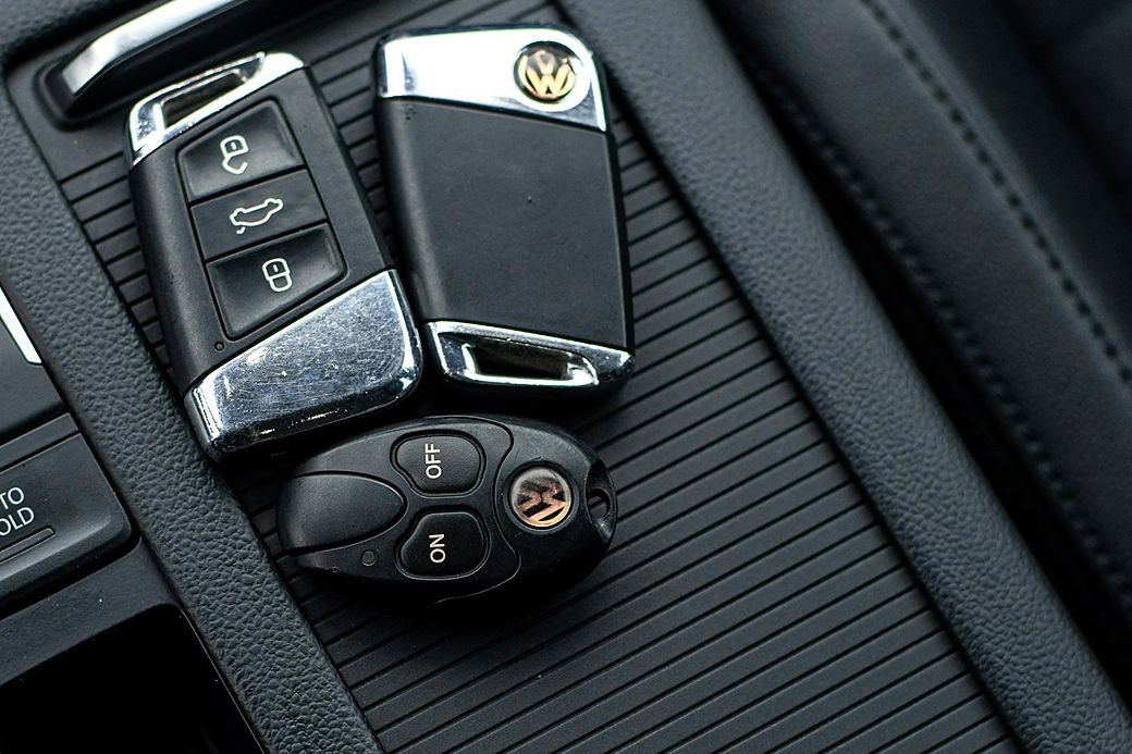 Two VW flip keys on the centre console of a car